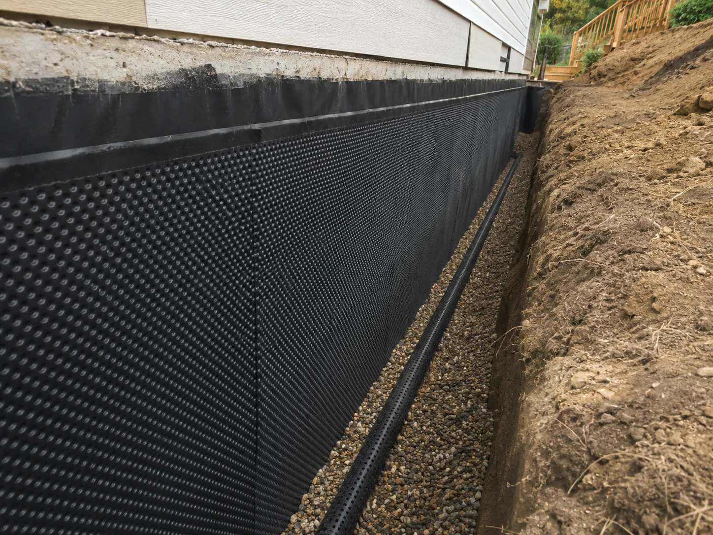 Waterproofing membrane and drainage board installed on foundation wall in Mississauga